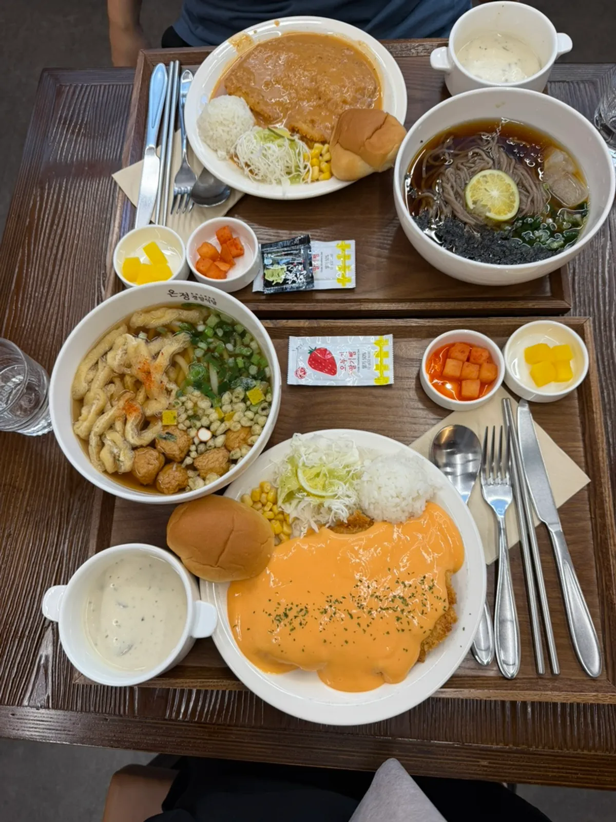 A plate of pork cutlet topped generously with cheddar cheese sauce