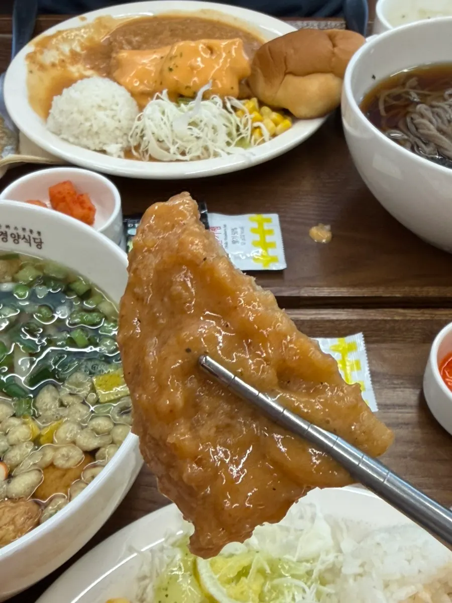 Pork cutlet set served with rice, cabbage salad, and a dinner roll