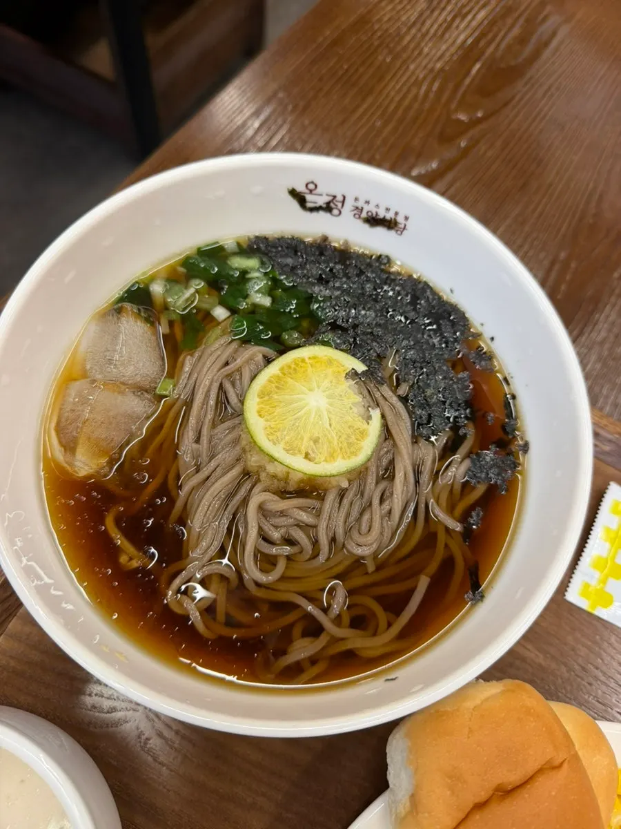Cold soba topped with a slice of green tangerine