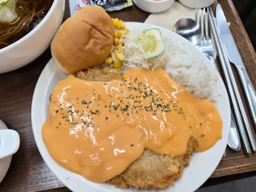 Close-up of the cheddar cheese cutlet piled with cheese