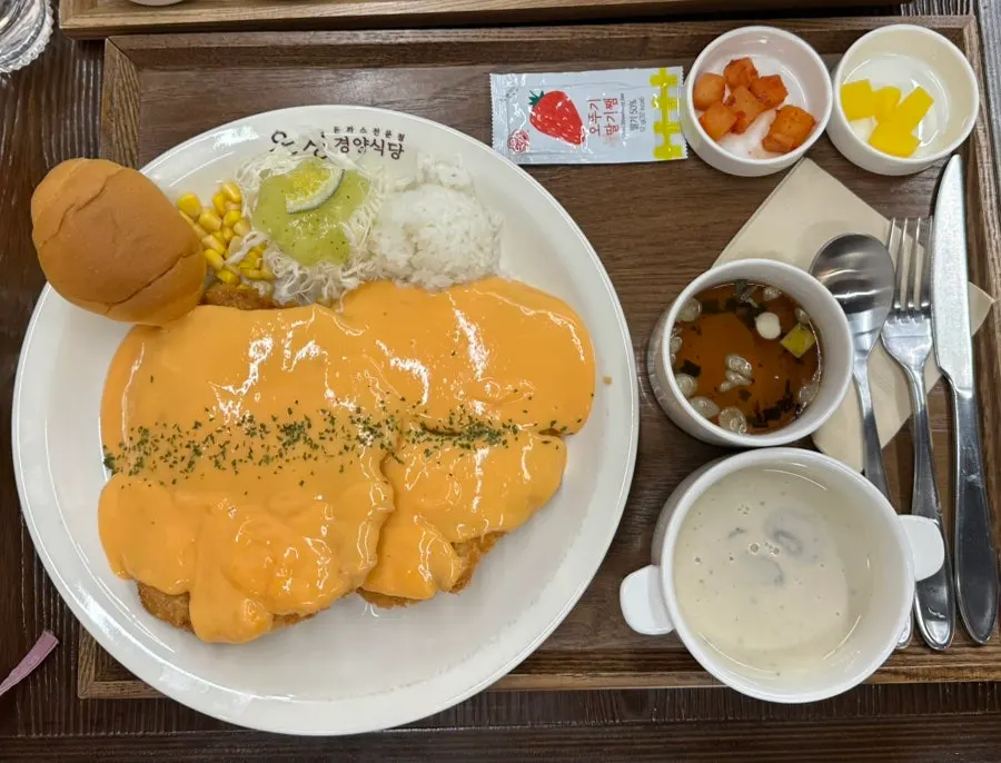 A plate of cheddar cheese cutlet topped with rich melted cheese