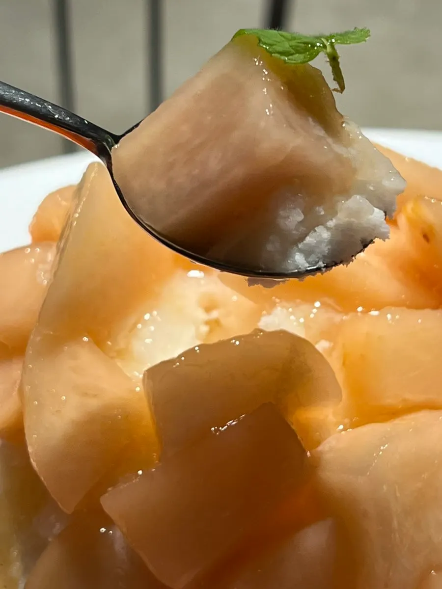 White peach bingsu served with red beans and condensed milk