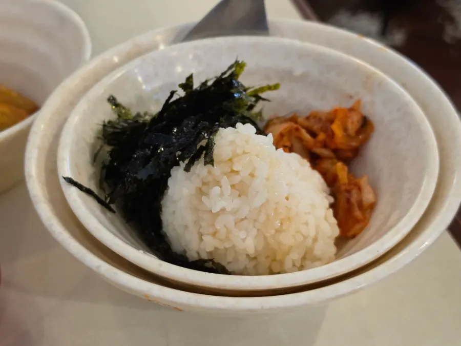 Fried rice ingredients: rice, seaweed flakes, corn kernels, and kimchi