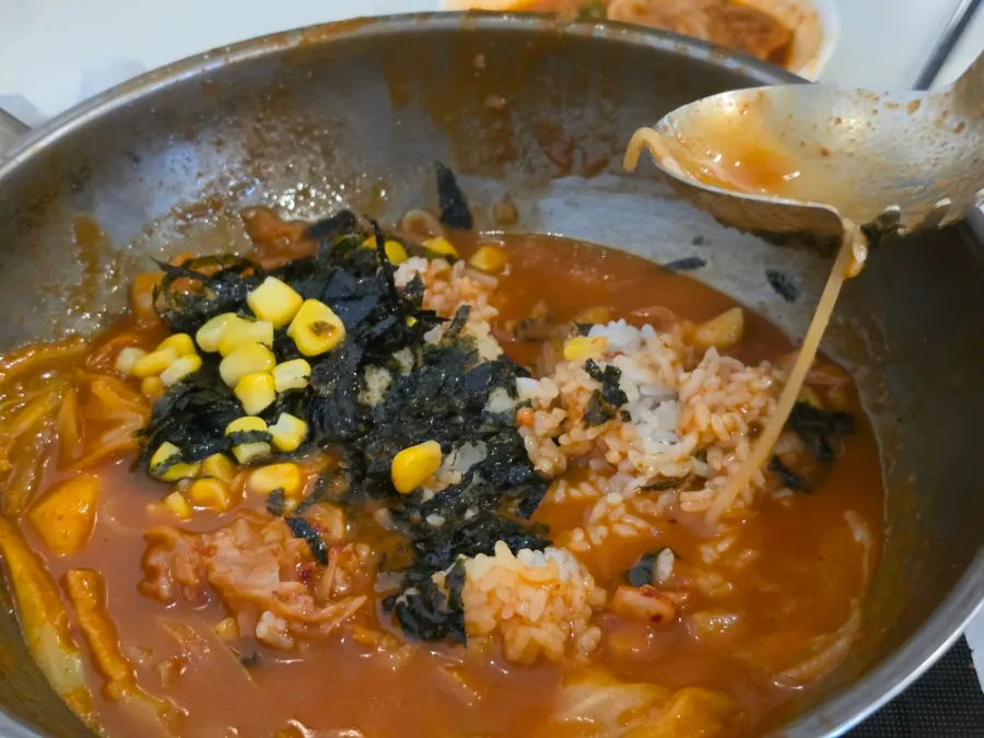 Pot with rice ingredients added into the leftover sauce