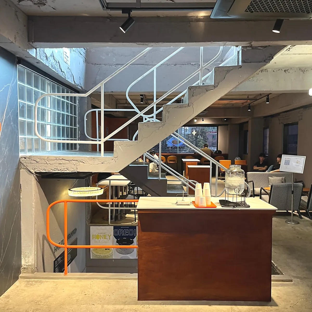 Interior of the 2nd floor café with exposed concrete and marble counter