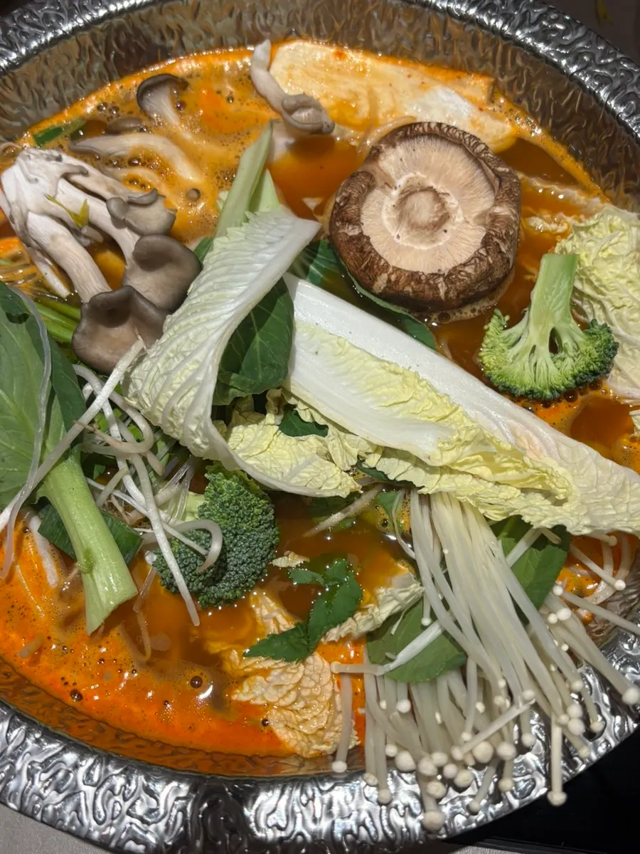 Red shabu broth filled with vegetables