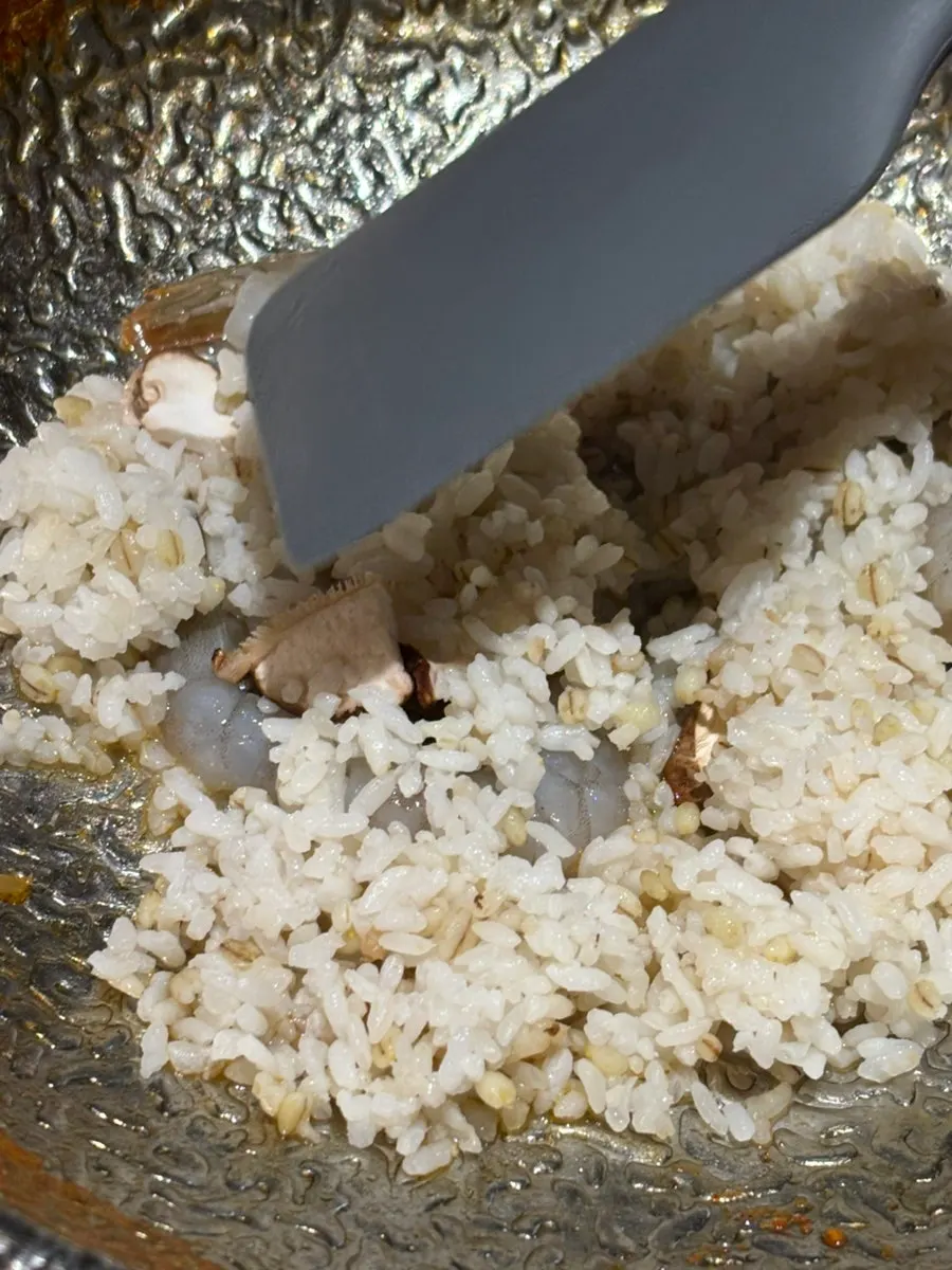 Rosé risotto being made with shrimp and mushrooms