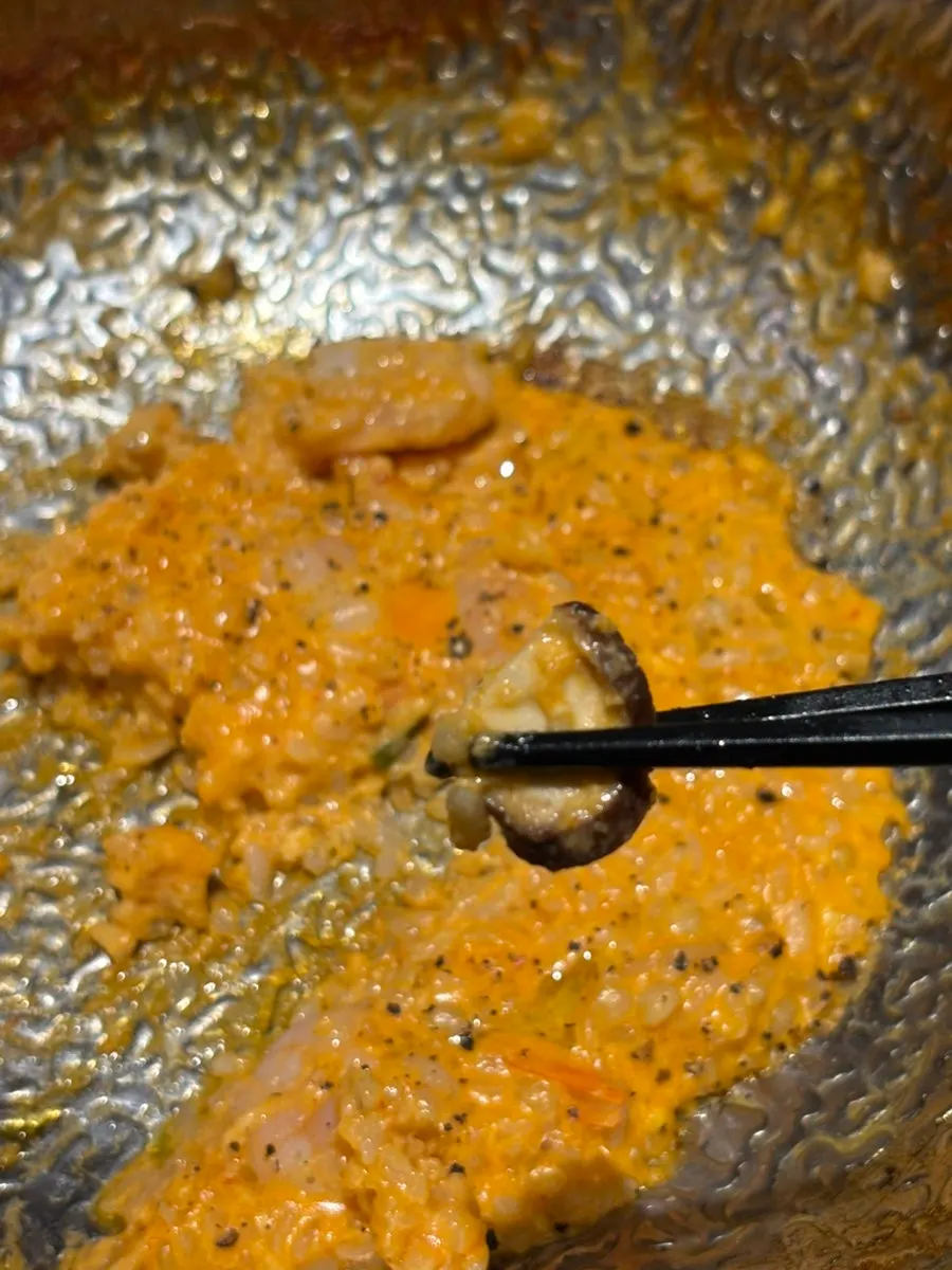Thick rosé risotto topped with mushrooms
