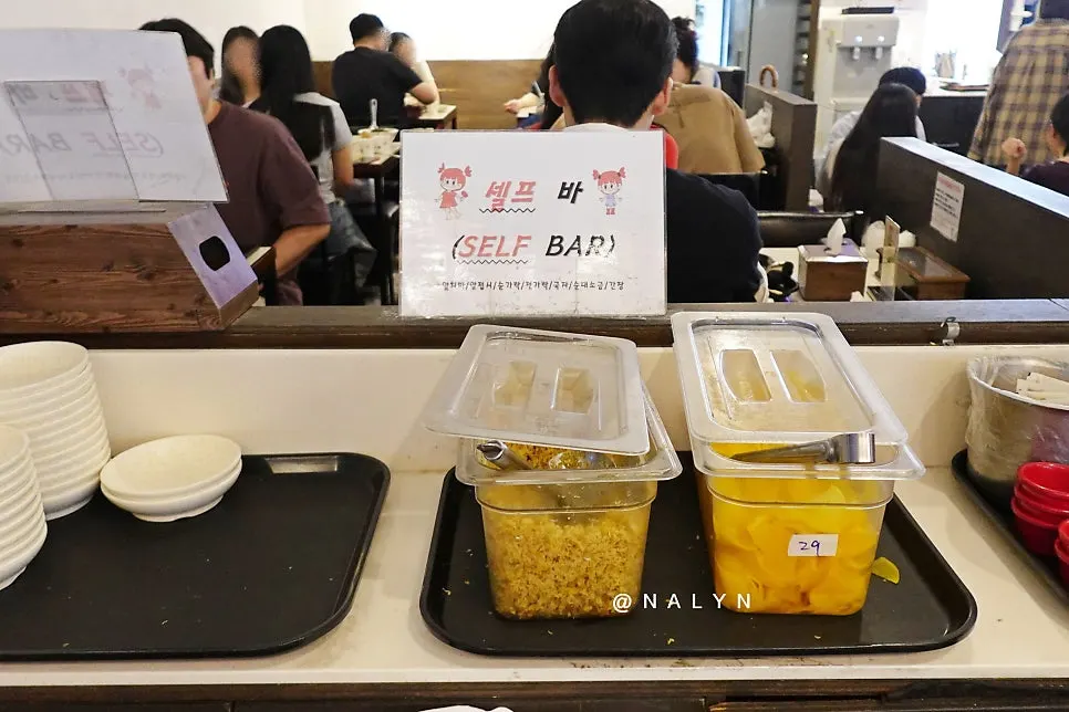 Korean snack dishes being set on the table