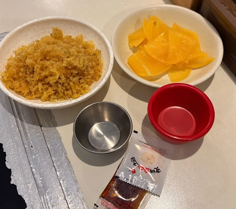 Self-service bar setup with fried crumbs and pickled radish