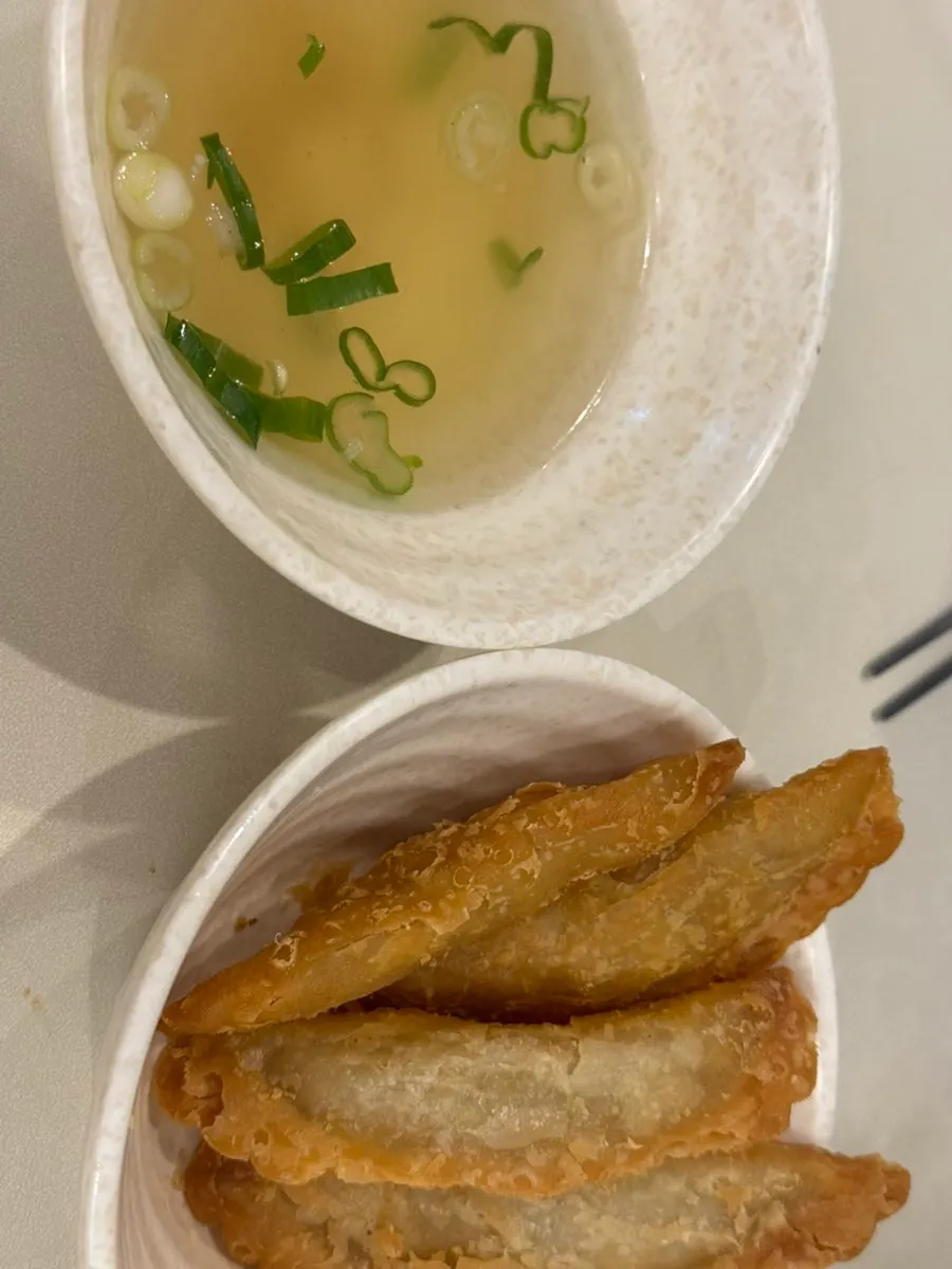 A ladleful of tteokbokki scooped up with broth