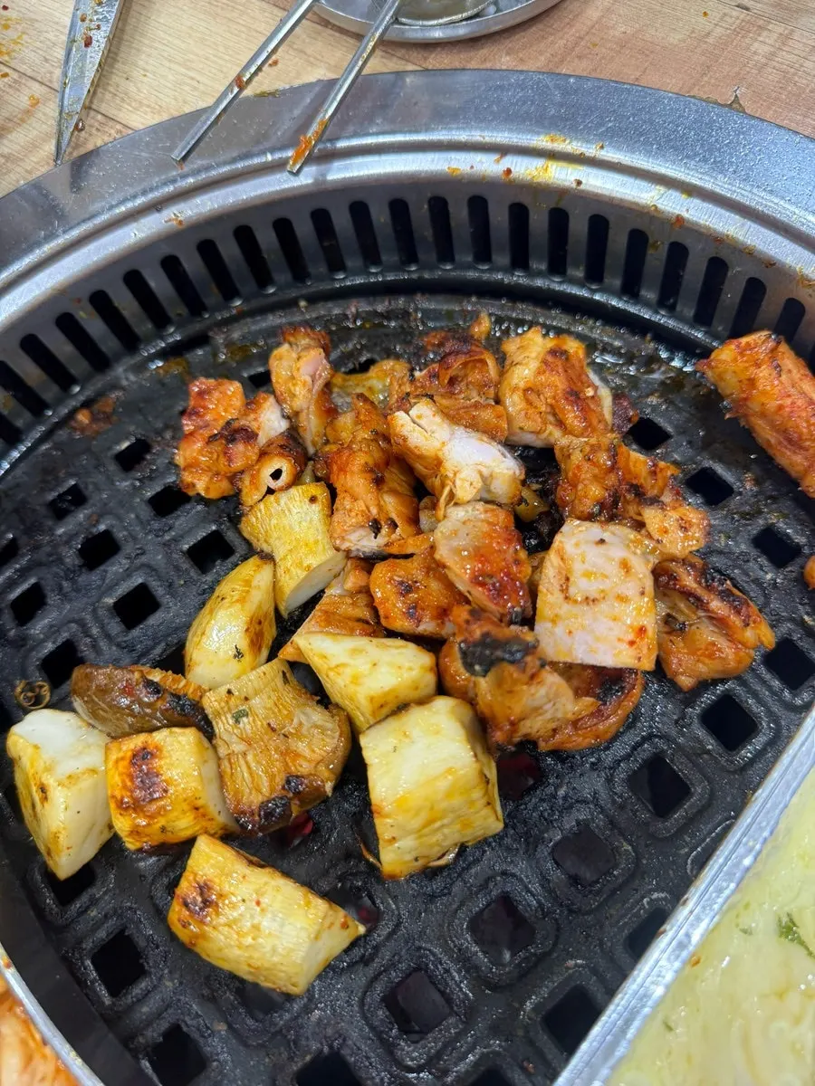 Partially grilled chicken on the barbecue