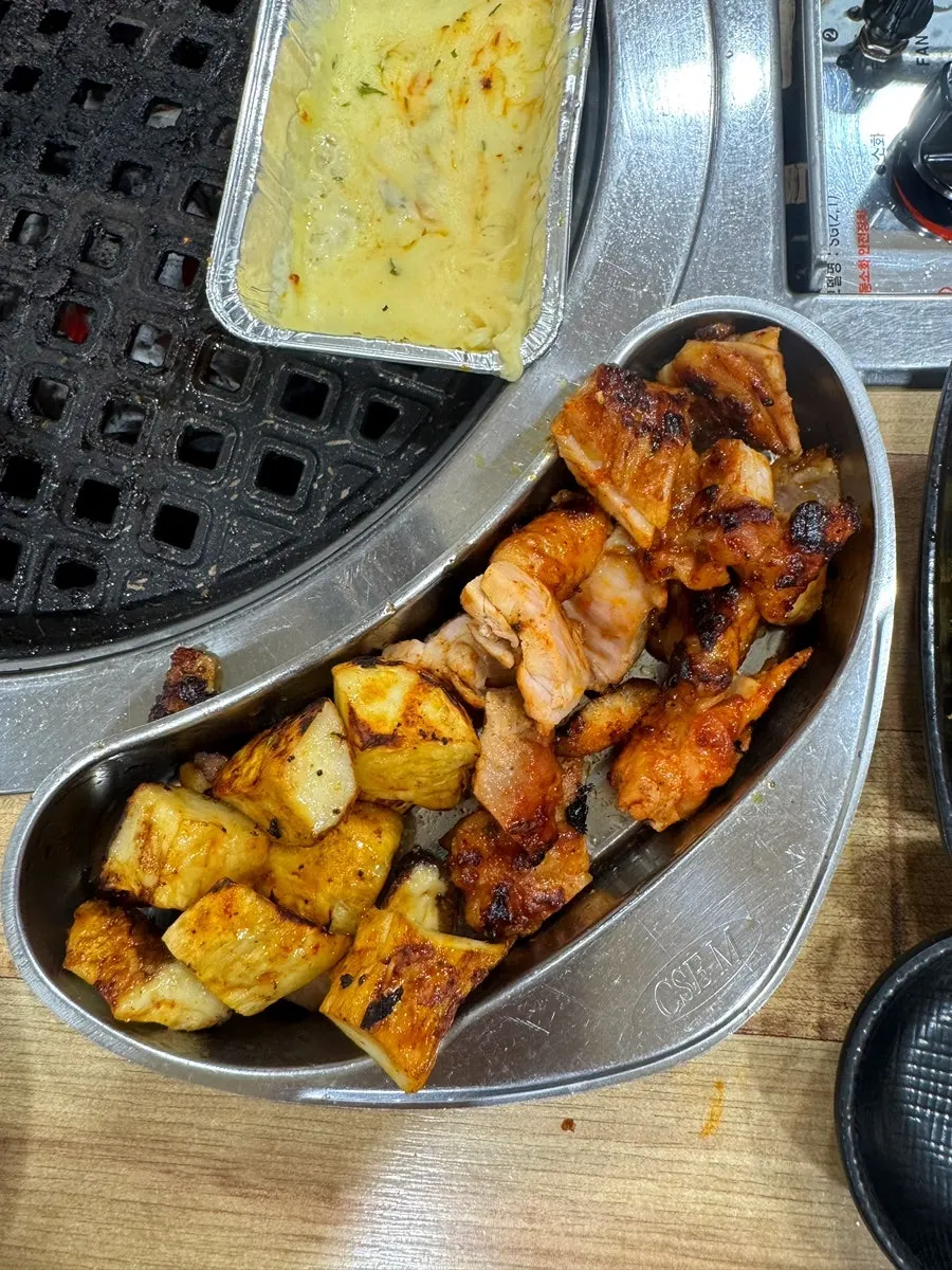 Charcoal-grilled chicken being cooked