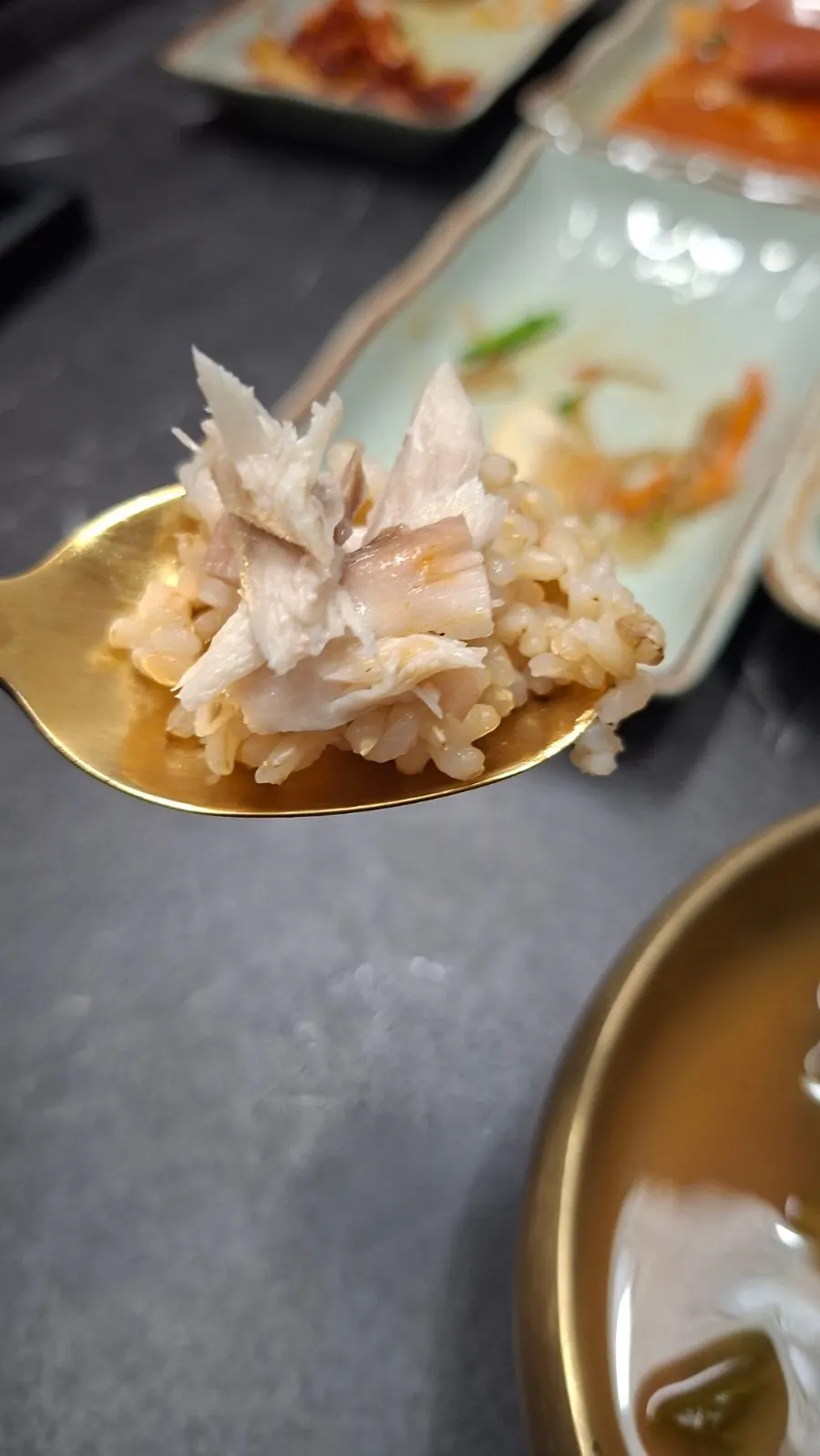 A piece of mackerel placed on top of brown rice