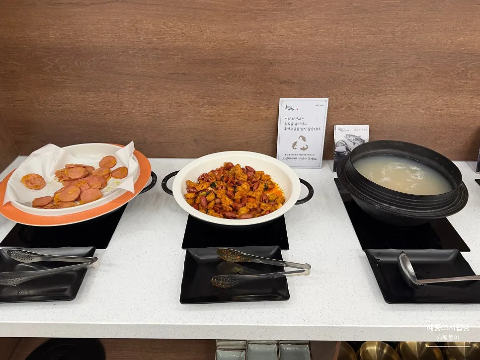 Self-serve side dishes including pink sausage, japchae, and braised tofu