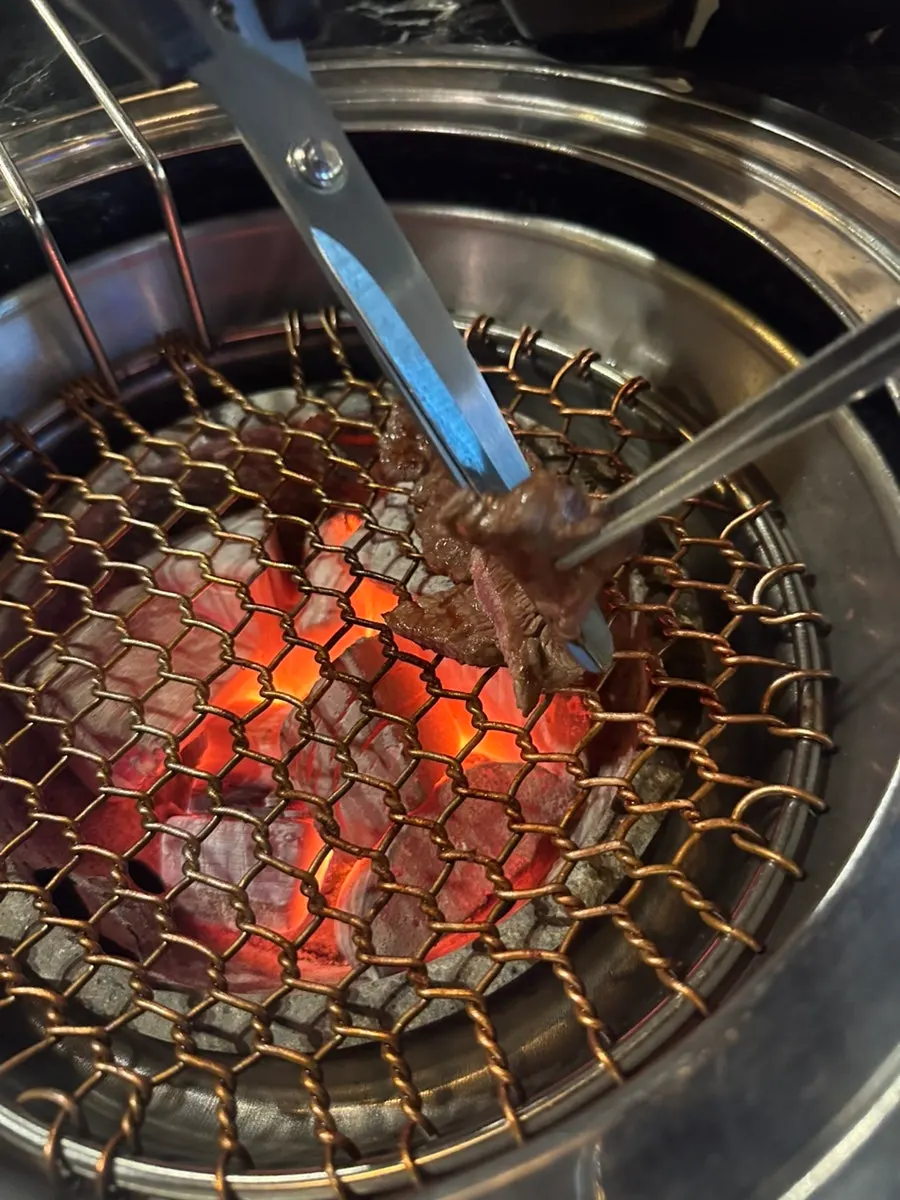 Beef grilling over the charcoal