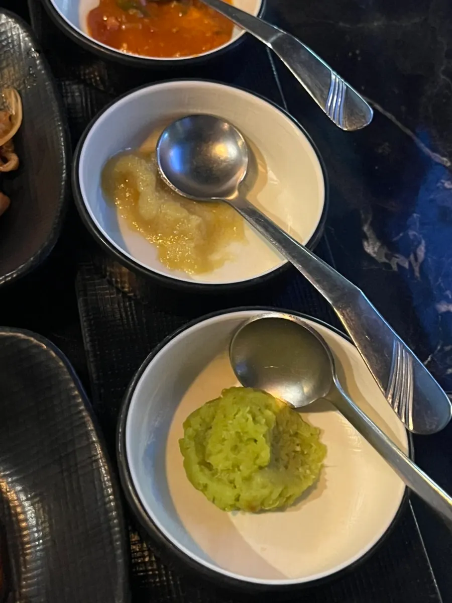 Seven dipping sauces served with the meat