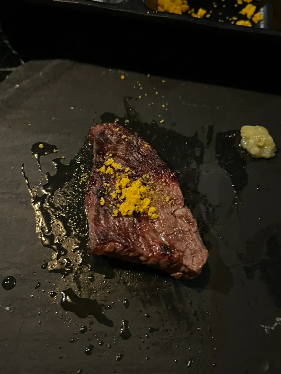 A piece of jingalbisal topped with sauce