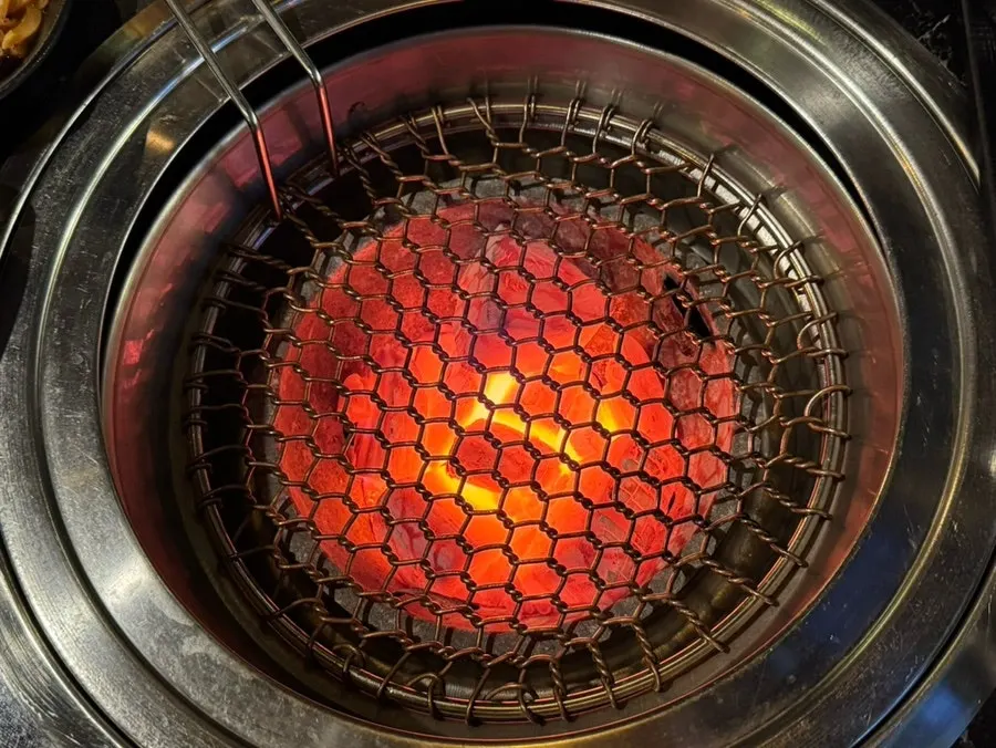 Personal charcoal grill and grate lit up red