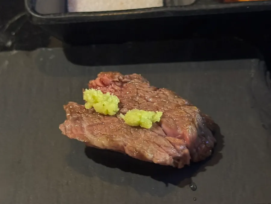 A piece of meat topped with wasabi