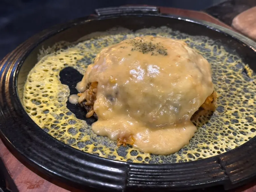 Fried rice topped with cheese sauce on the hot plate