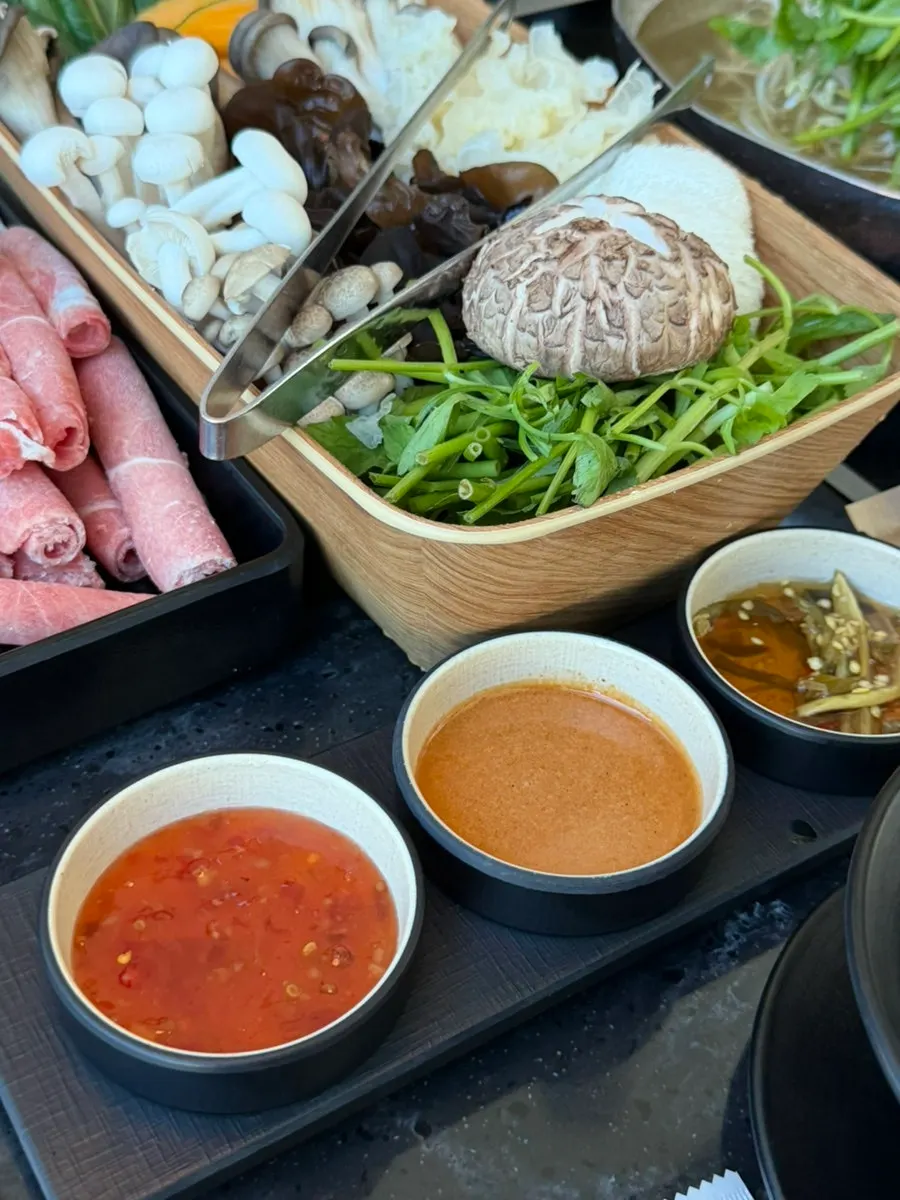 Three house-made sauces: chili, peanut, and chili soy