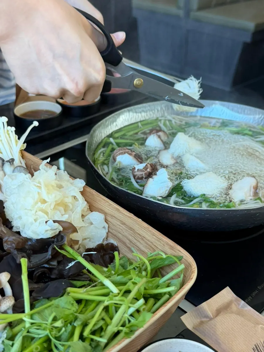Mushrooms and vegetables added to the boiling broth