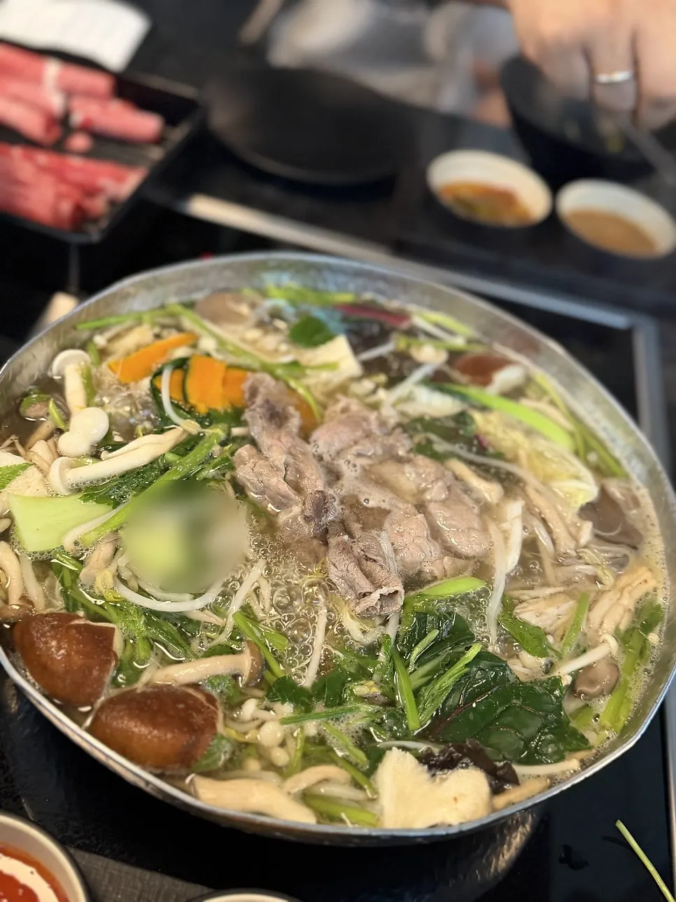 Pot of boiling anchovy broth with vegetables added