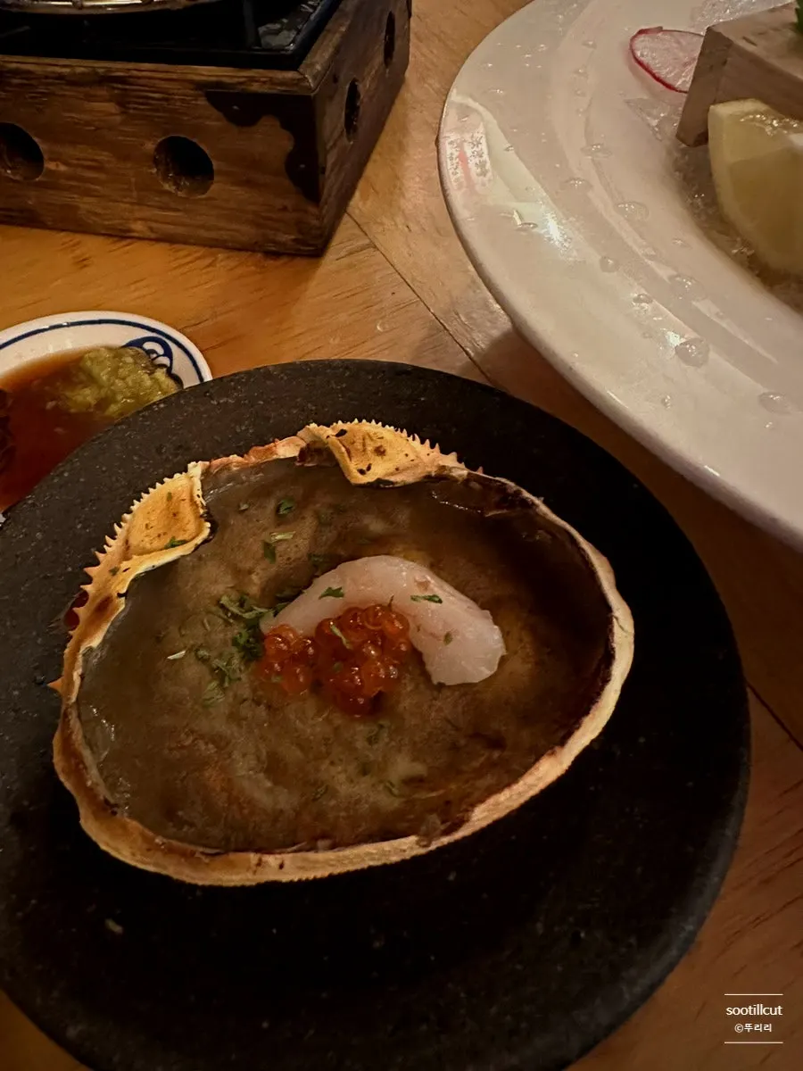 Grilled crab innards in the shell