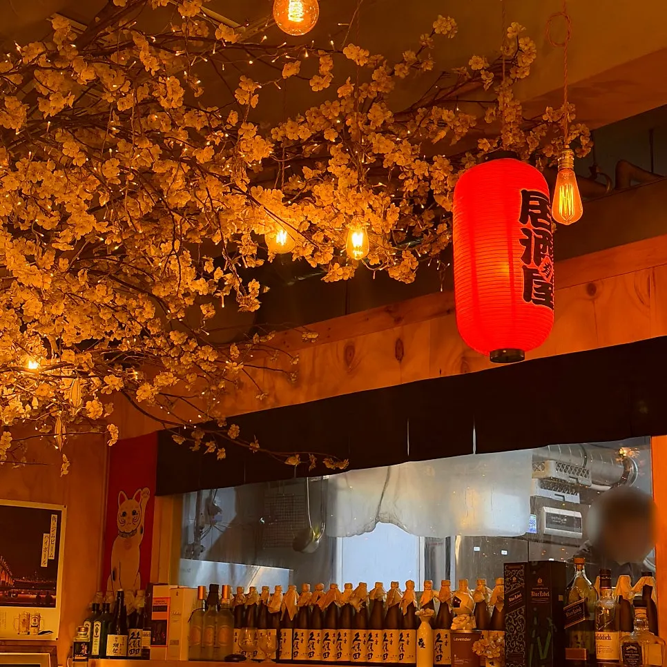 Corner of the restaurant displaying red lanterns and Japanese props