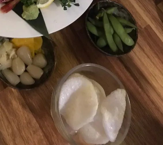 Pickled shallots, pickled ginger radish, and shrimp chips side dishes