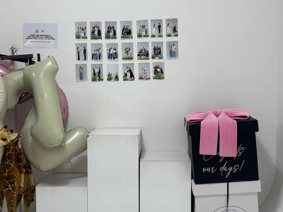 Artificial flowers and a giant gift box prop