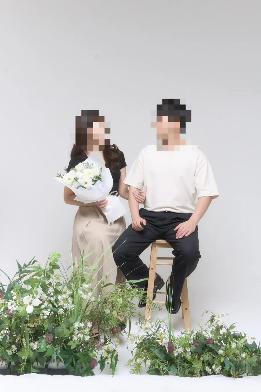 A full-body couple shot taken while sitting in chairs
