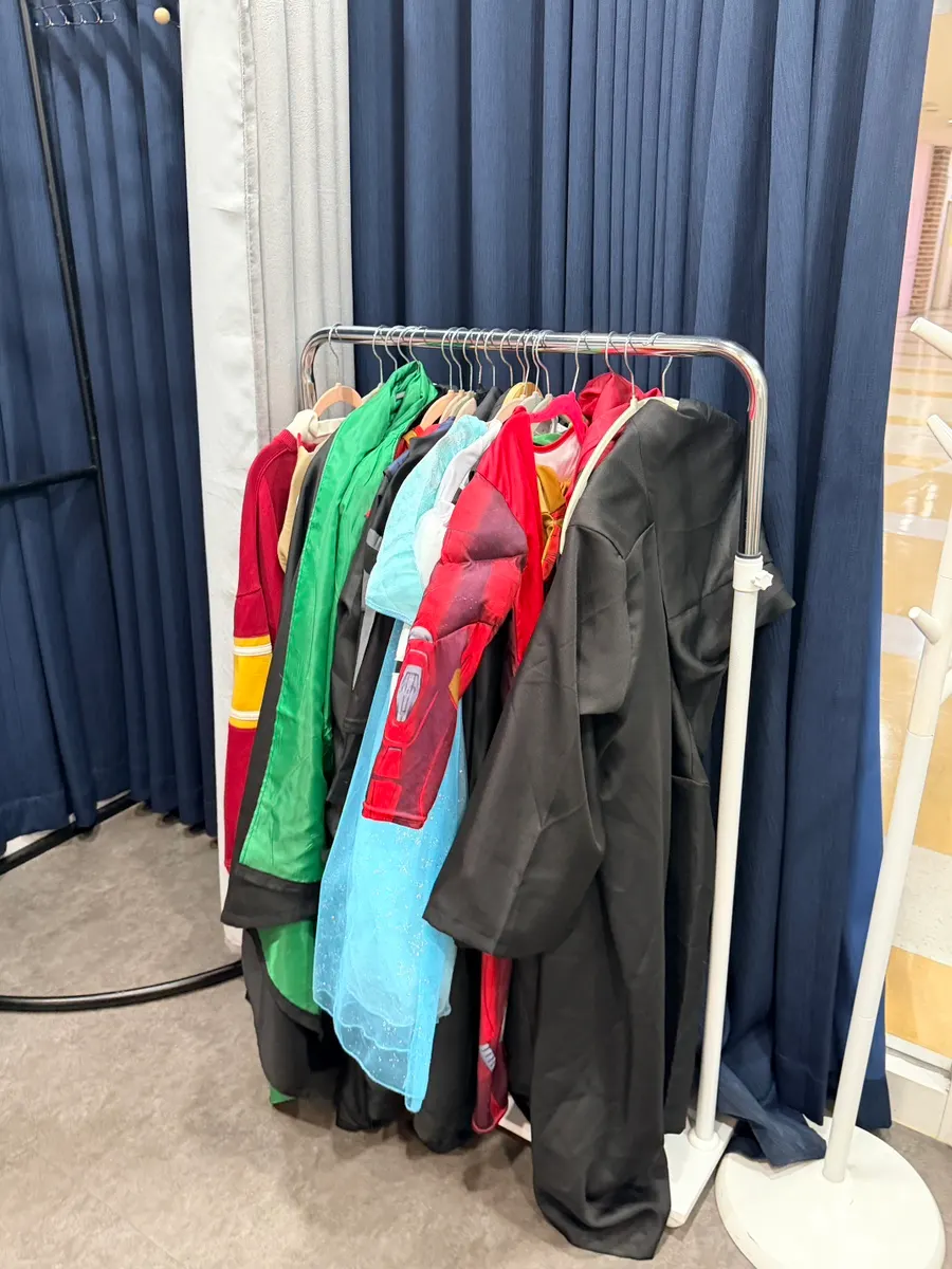 Prop corner with children's character costumes hanging up