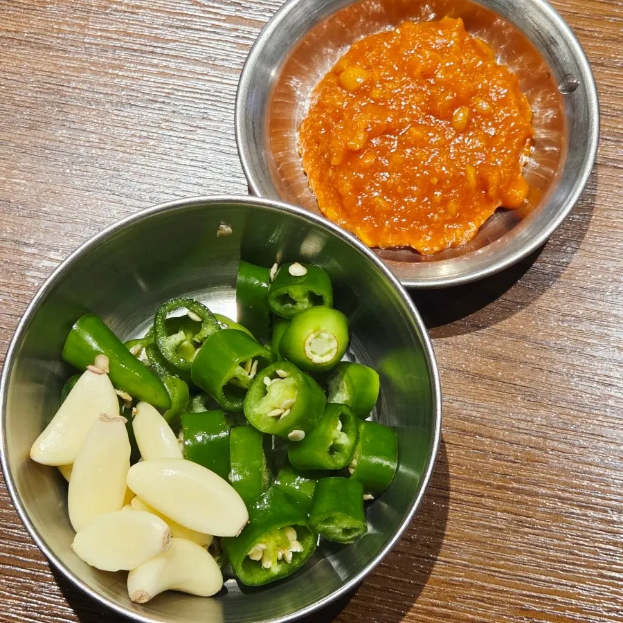 Small dish of ssamjang and garlic with cracked black pepper