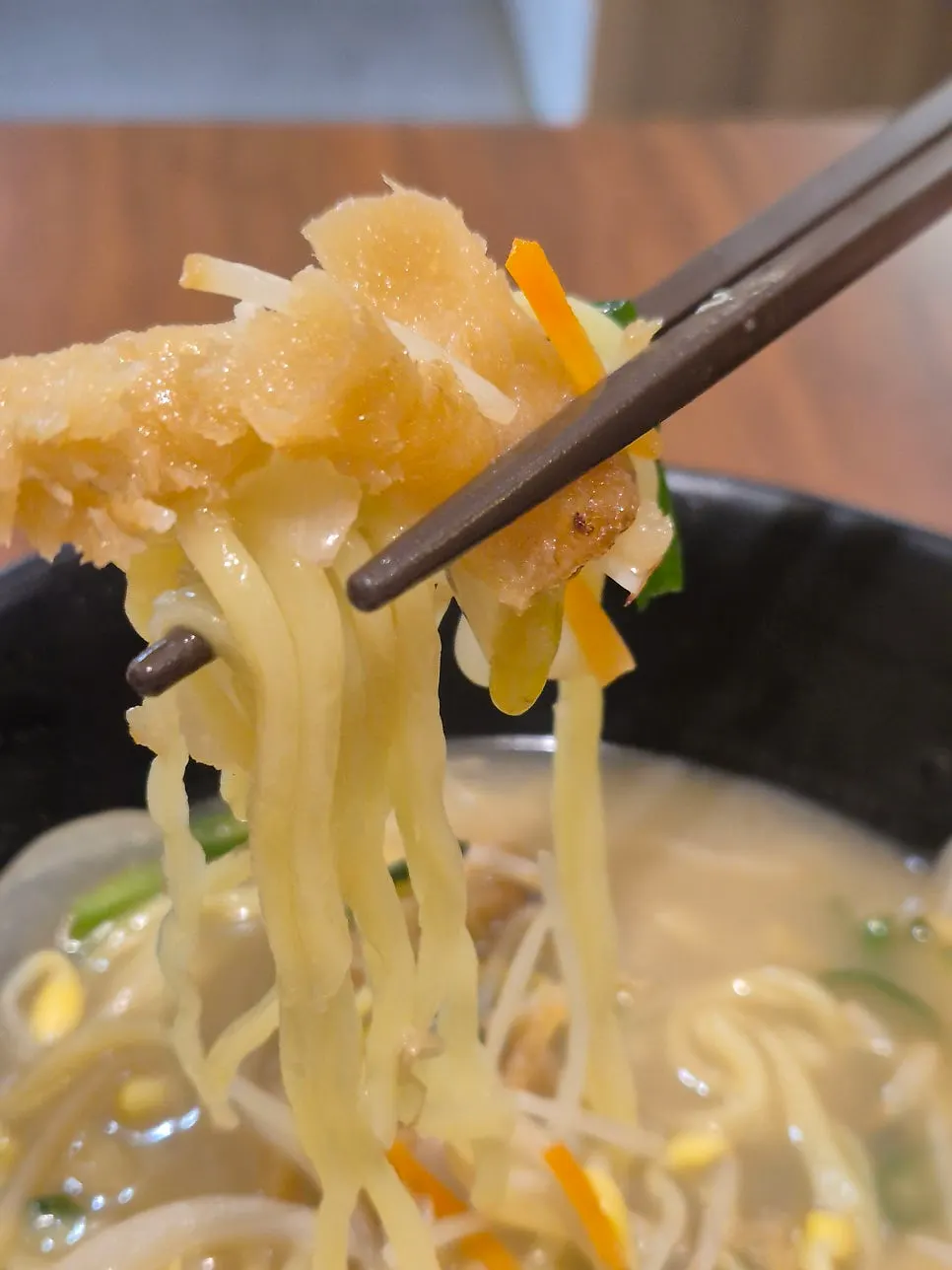 A spoonful of hwangtae jjampong broth being lifted