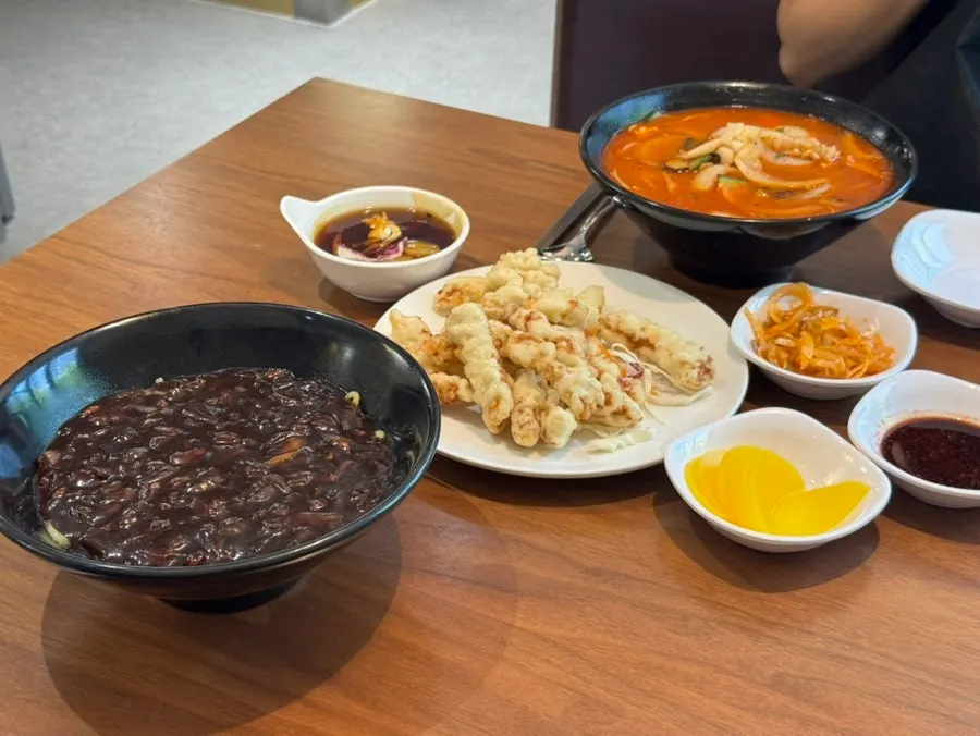 Table spread of jjajangmyeon, jjampong, and mini tangsuyuk