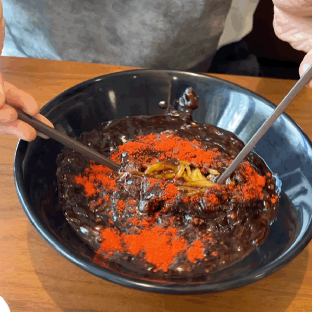 Signature jjajangmyeon sprinkled with chili powder