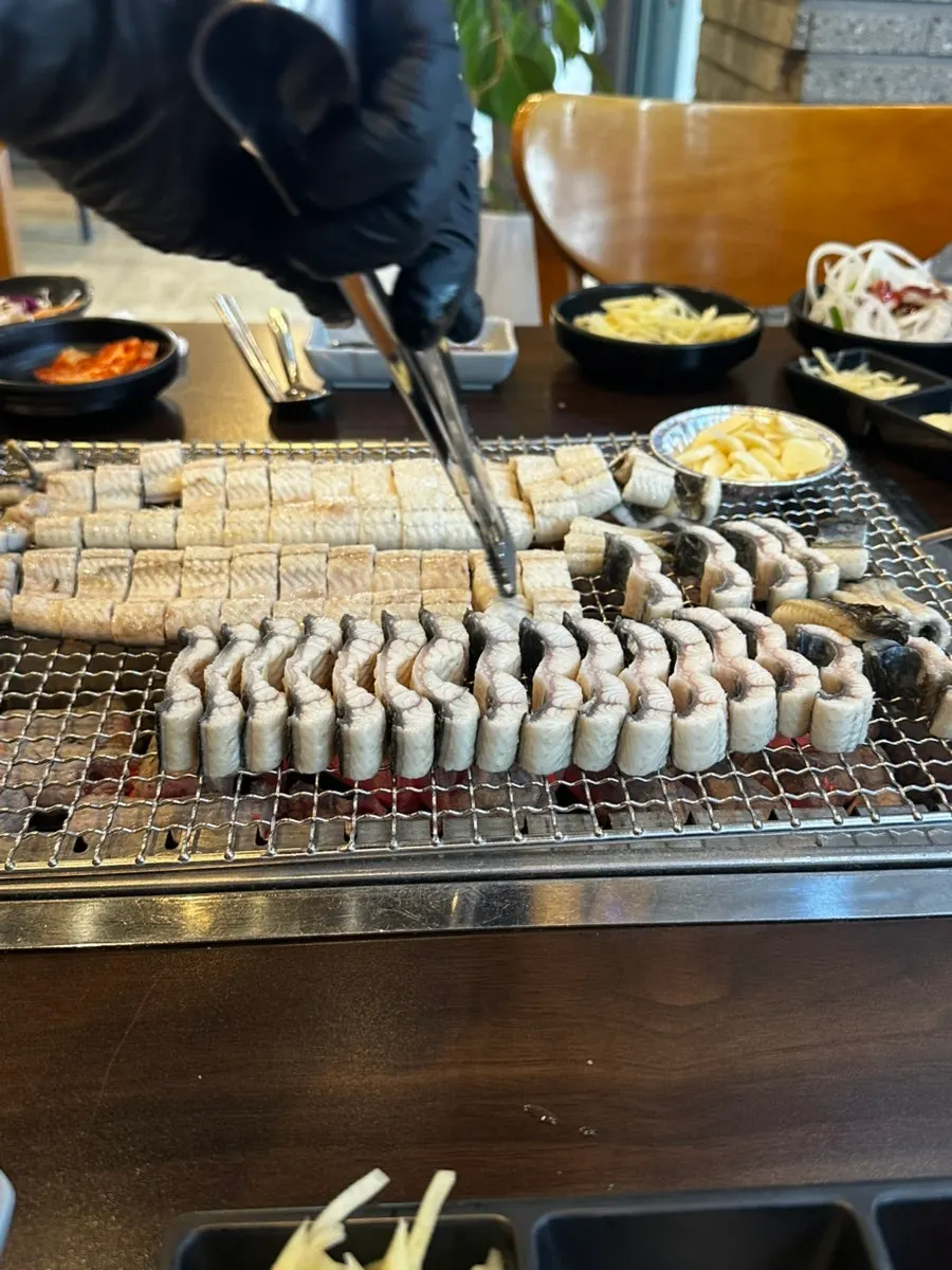 Pre-grilled eel placed on the charcoal grill