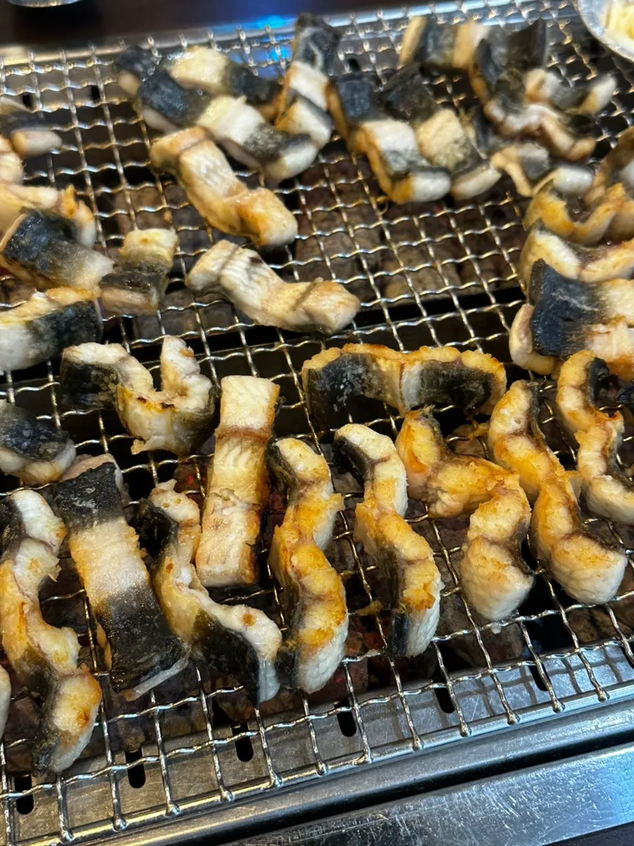 Plump eel grilled standing on its side