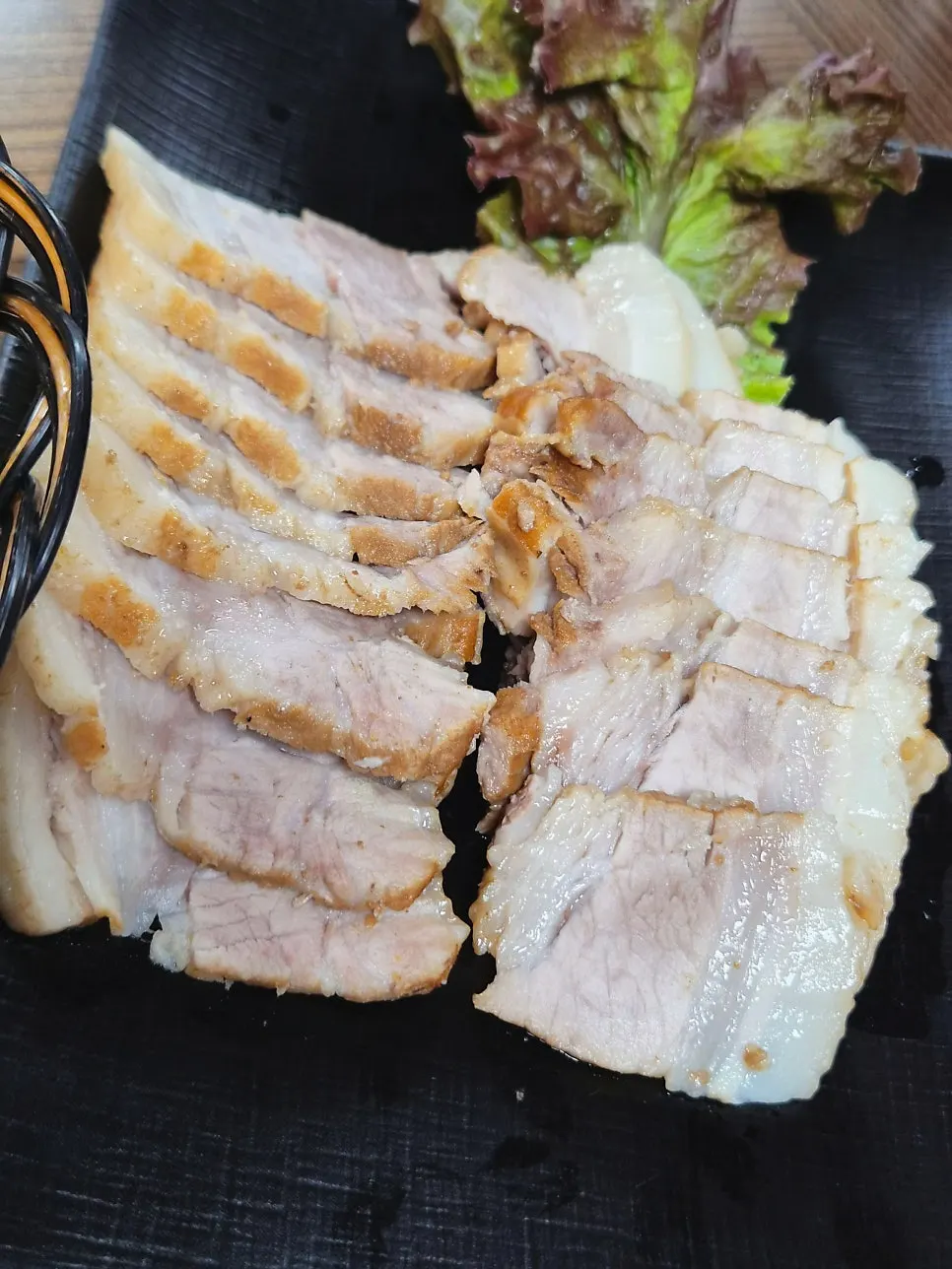 Close-up of the chewy texture of the pork belly herbal bossam