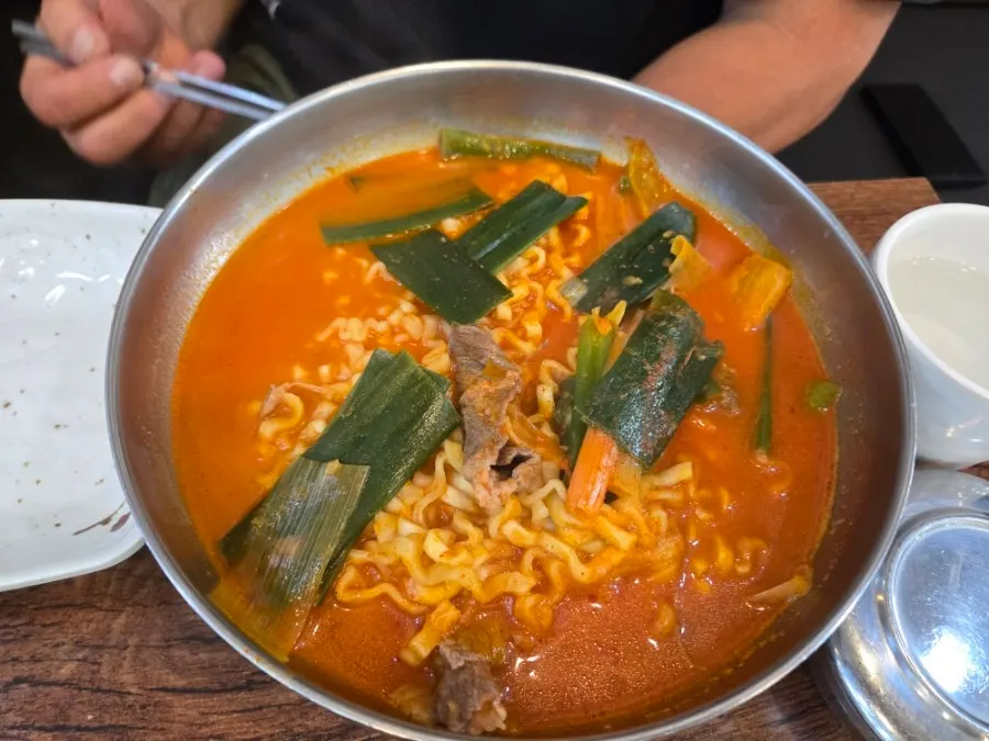 Brisket yukkal-myeon with knife-cut noodles and a bowl of rice