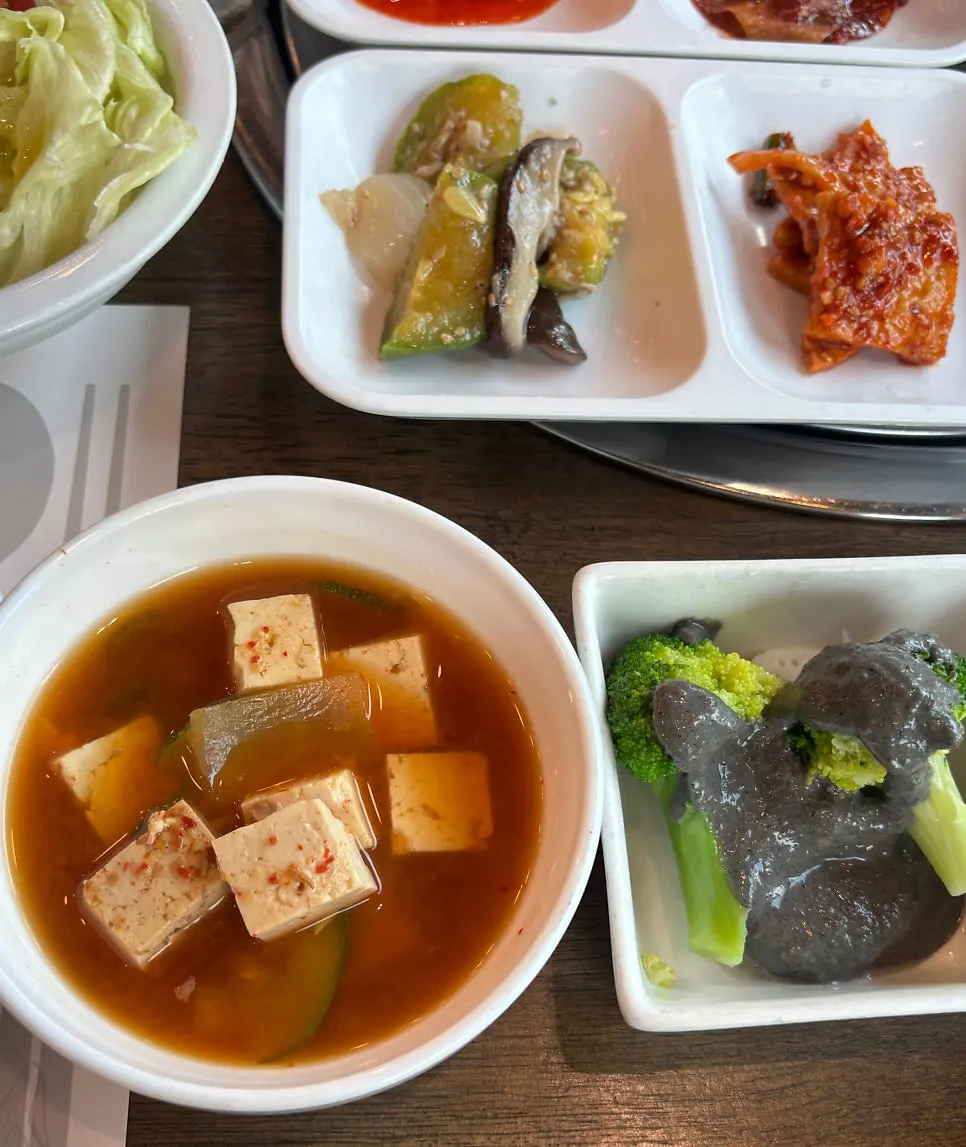 A neatly plated dish of seasoned vegetable side dishes