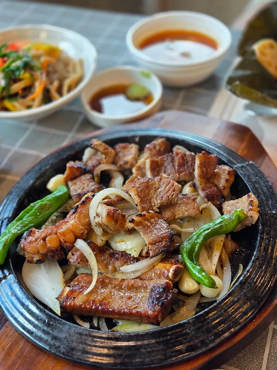 Eating pork galbi wrapped in lettuce