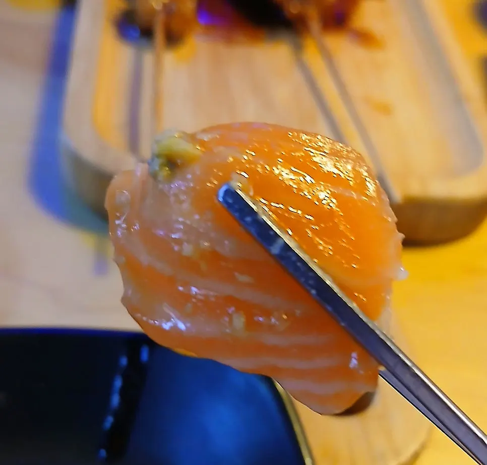 A plate of raw salmon yukhoe with wagyu yukhoe and gravlax salmon