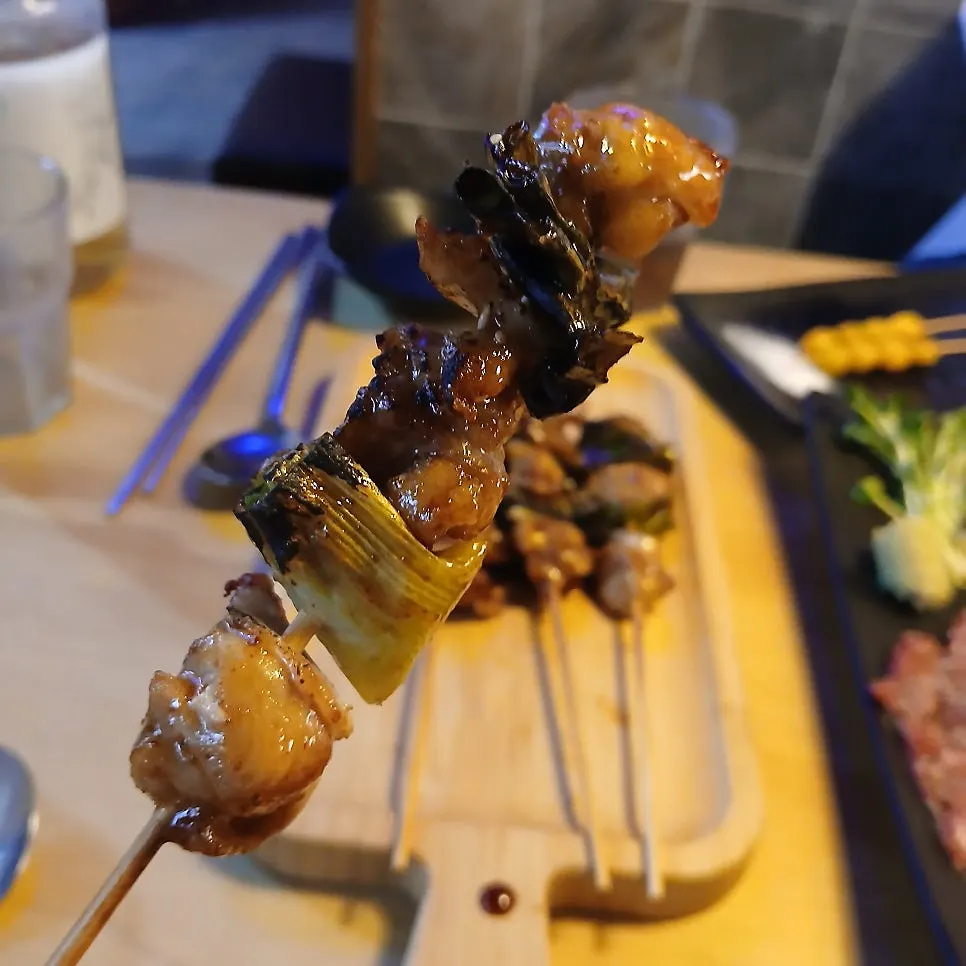 A spread of multiple skewers and side dishes
