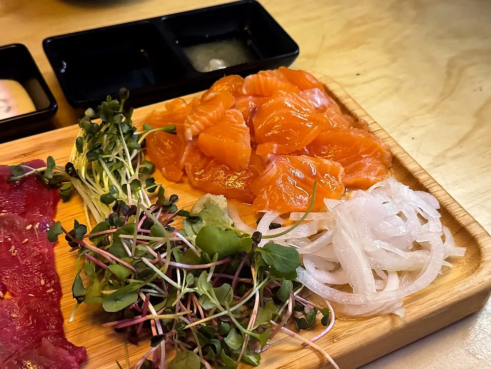 Platter split between raw beef and salmon