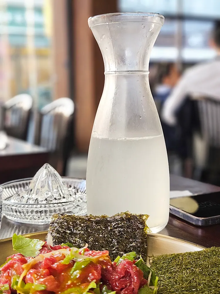 A glass of soju paired with fresh lemon