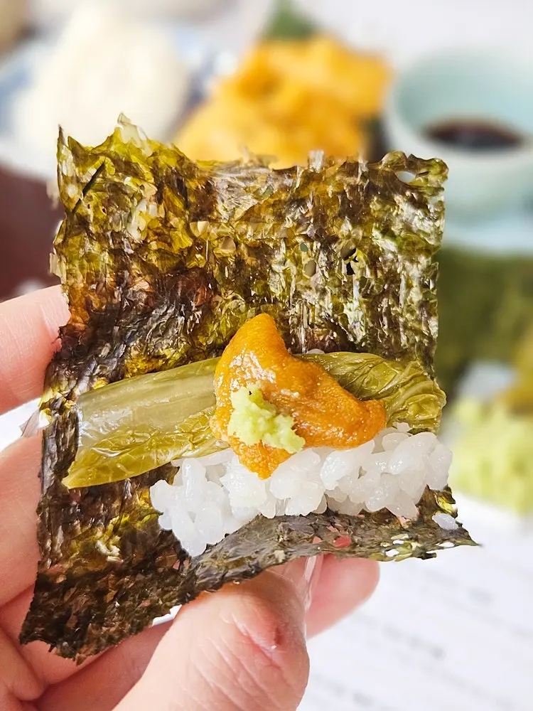 Picking up a piece of yukhoe with chopsticks