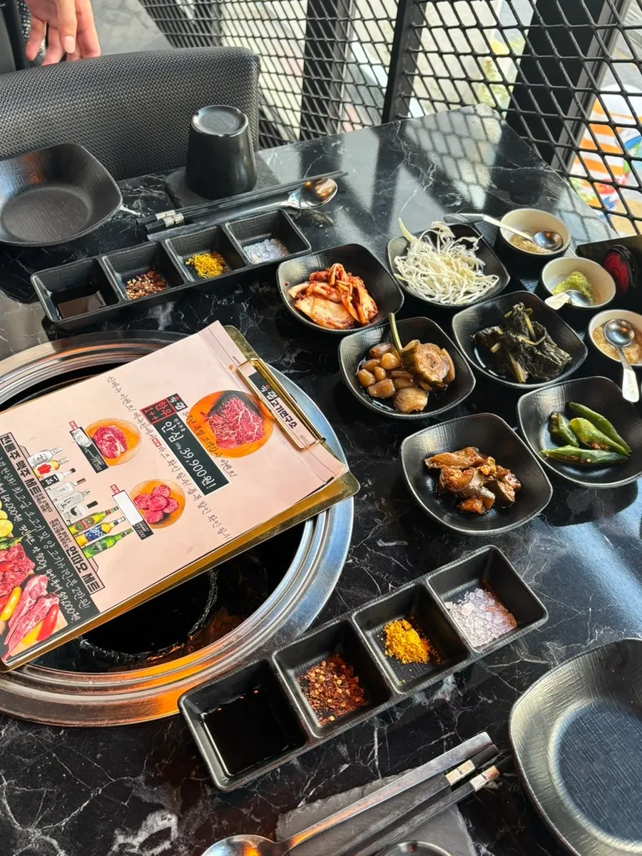 Side dish spread at Yukrab with kimchi and wild garlic leaves